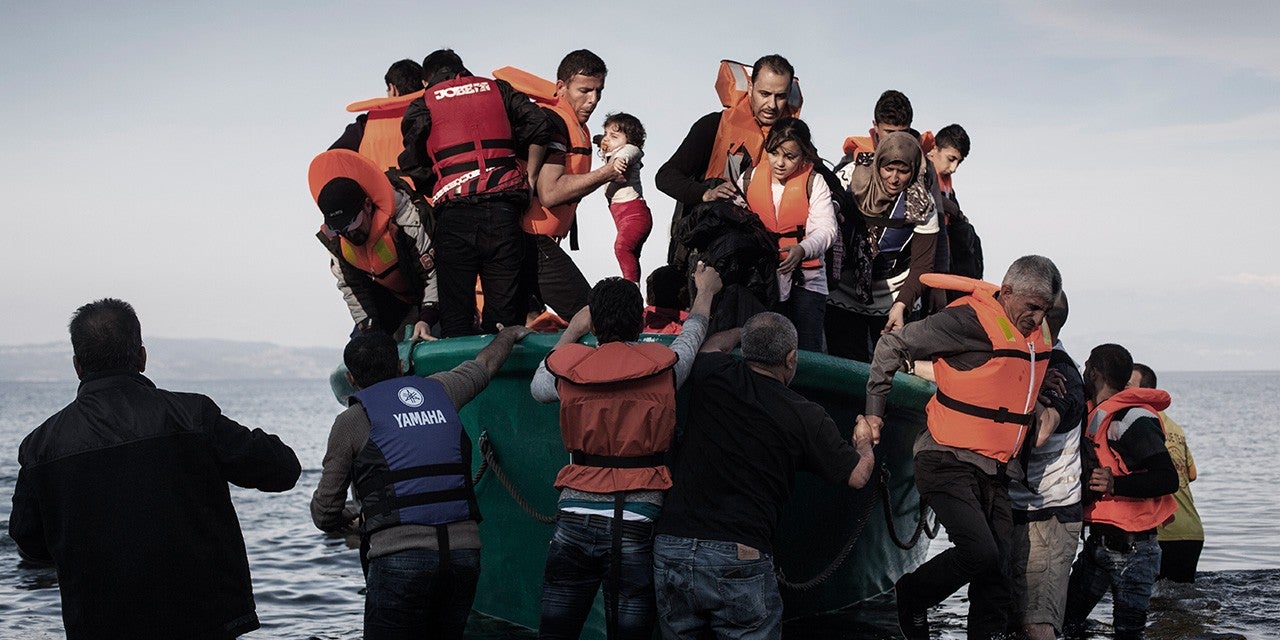 Photo of Refugees from Afghanistan and Syria arriving in a boat