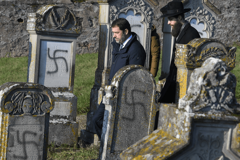 Swastika spray-painted on headstones in a Jewish cemetery