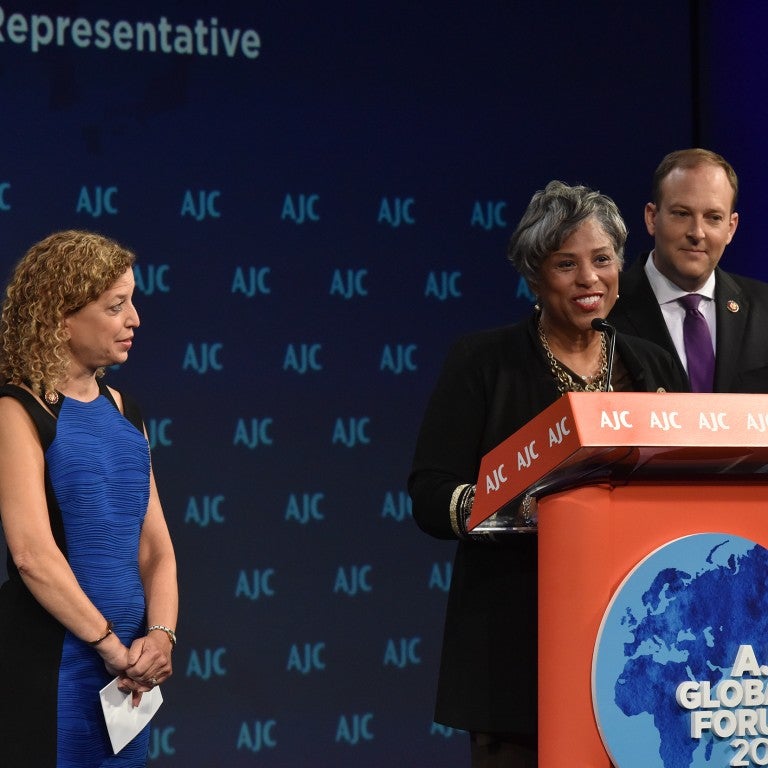Photo of Rep. Brenda Lawrence addressing AJC Global Forum 2019 with Reps. Debbie Wasserman-Schultz and Lee Zeldin.