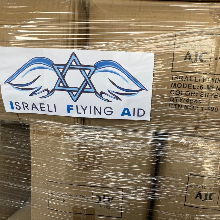 Israel Flying Aid text on boxes with AJC on them