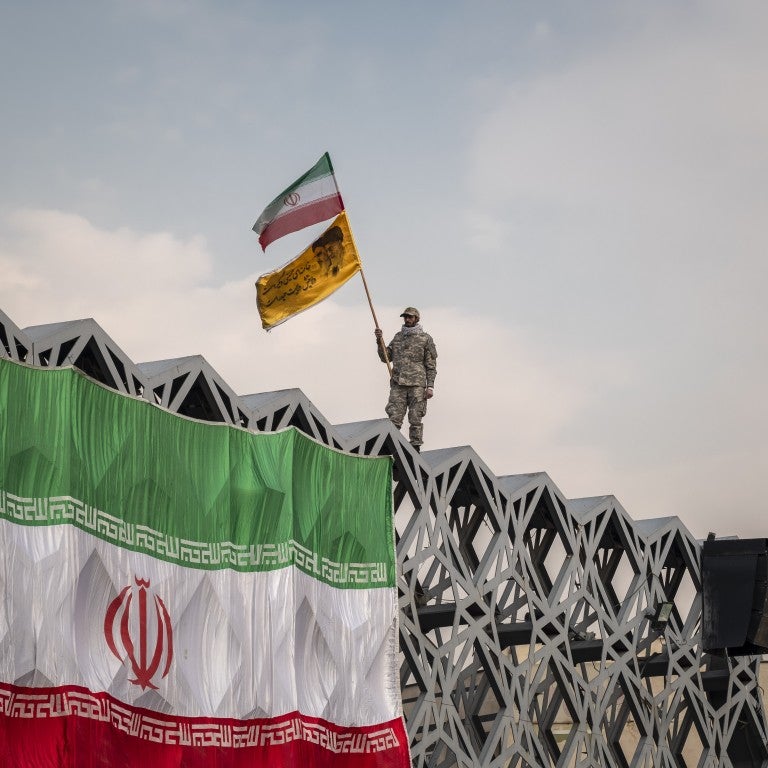 Man holding Iran flag