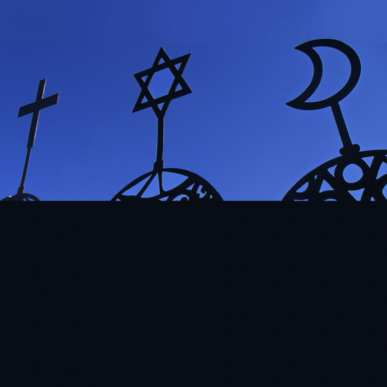 Photo of a cross, jewish star, and crescent moon on a blue background