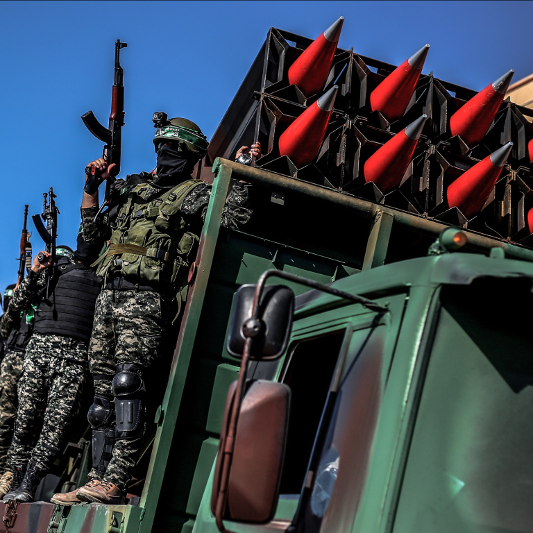 Members of Hamas display rockets during a military parade